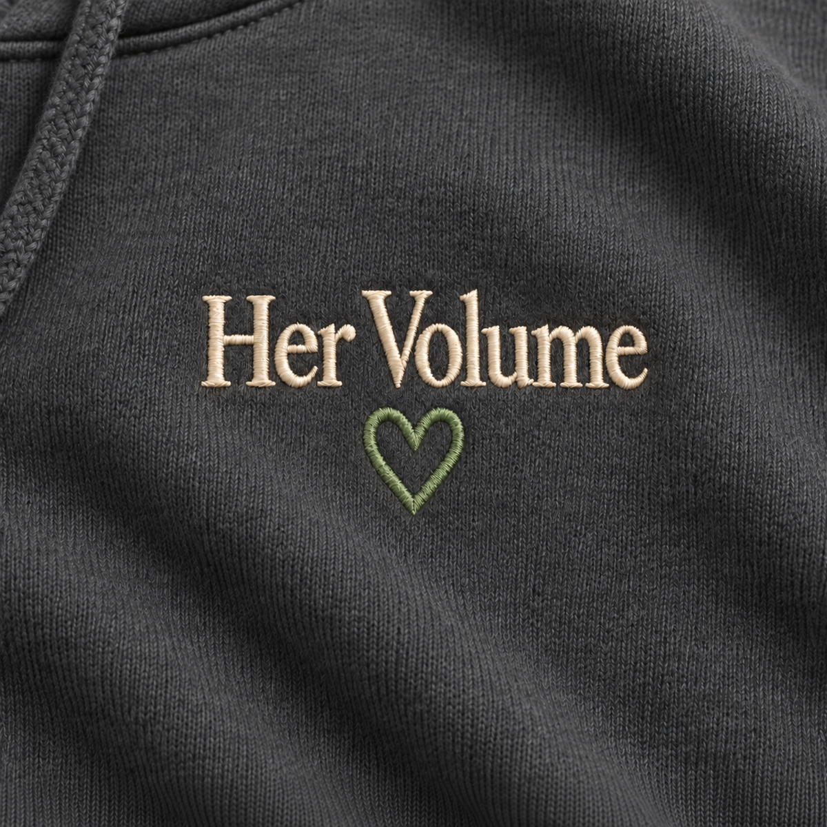 Illustrative AI mockup of ivory Her Volume embroidery and sage heart; not a photograph of a finished sample.