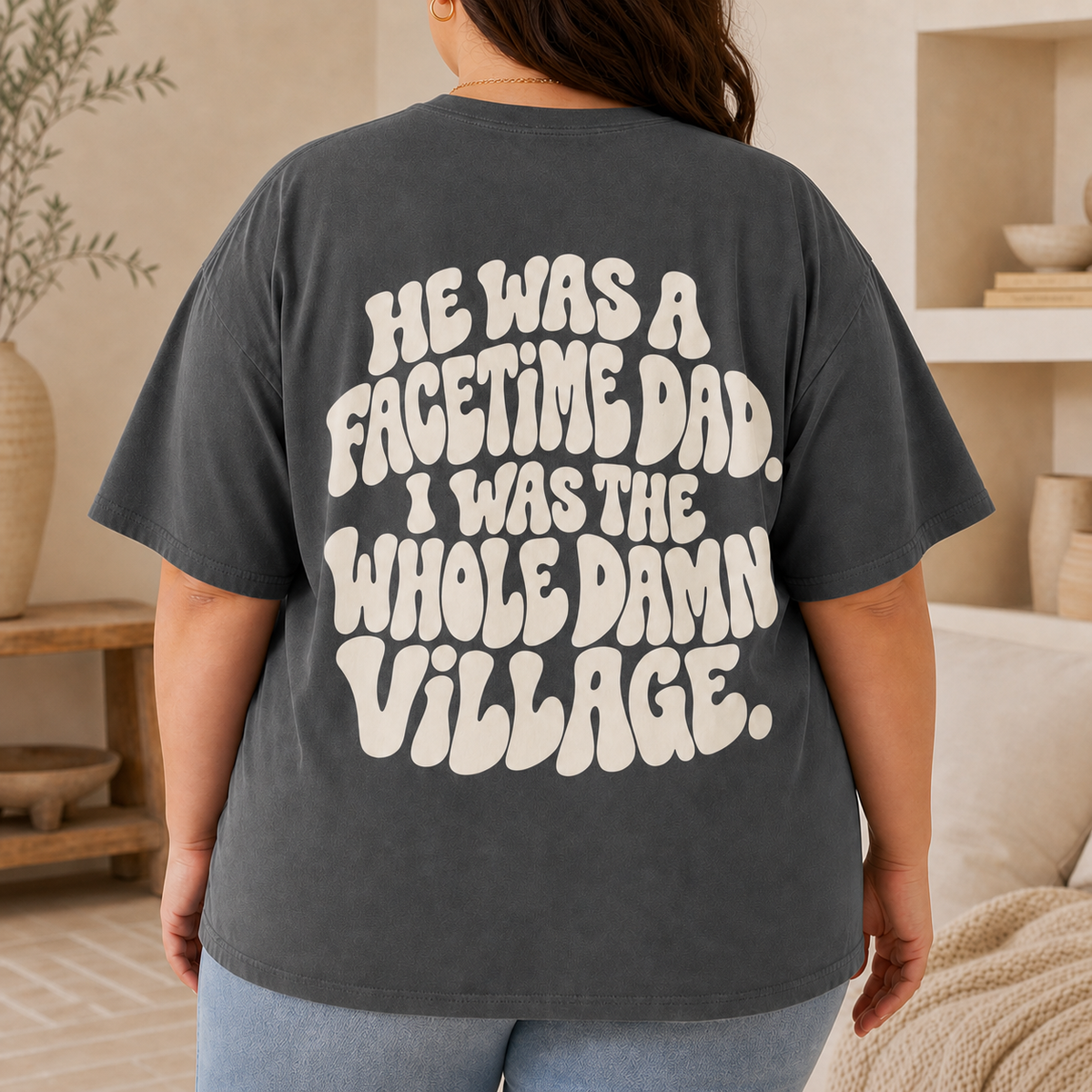 Curvy plus-size woman wearing the Pepper Whole Damn Village oversized tee, back view