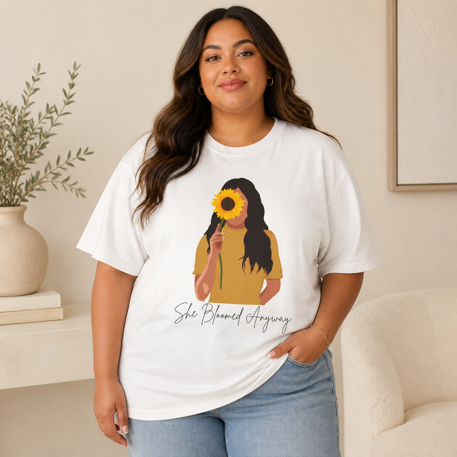 Curvy plus-size woman wearing the white She Bloomed Anyway oversized Comfort Colors tee