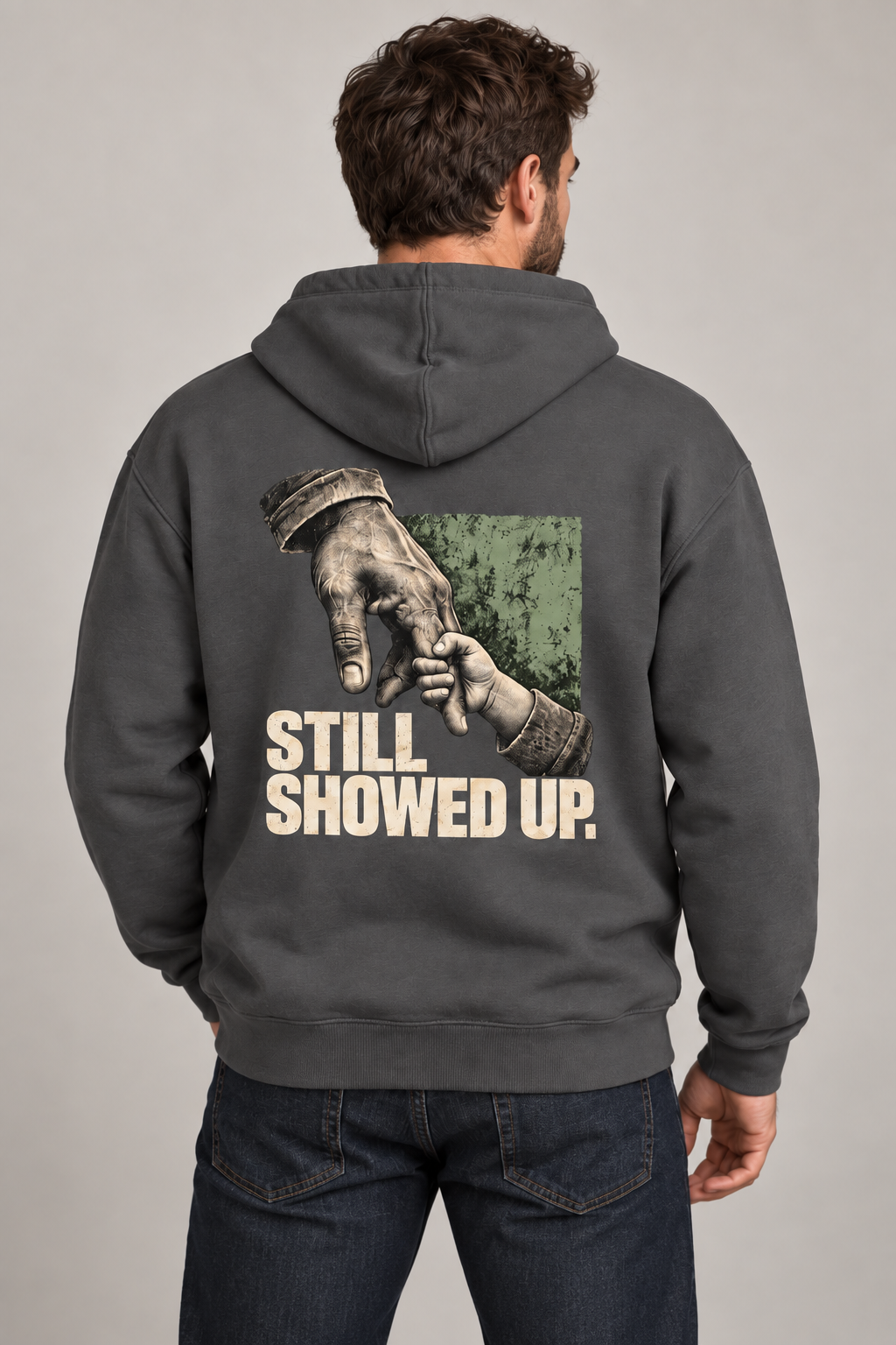 Back-view AI model mockup of Still Showed Up hoodie with father-and-child hands and sage accent.